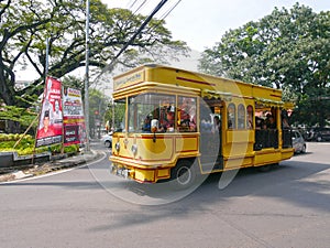 Yellow Tour Bus in Jl. Martadinata in Bandung, Indonesia