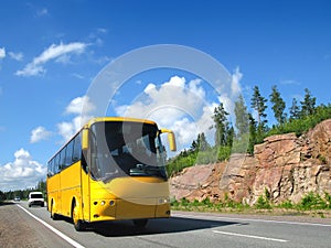 Yellow tourist bus on country highway