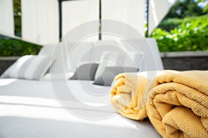 Yellow towel folded on bed pool at the spa