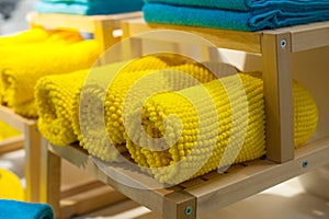 Yellow towels on the shelf in the closet