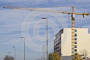 Yellow Tower Crane at the Construction Site on a Cloudy Day