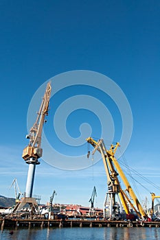 Yellow towers crane with blue sky photo