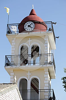 Yellow the town hall with clock in Moraitika. Corfu. Greece.