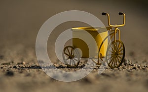 A yellow toy bike outdoors