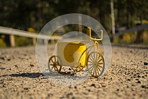 A yellow toy bike outdoors