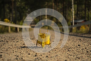 A yellow toy bike outdoors