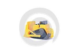 The yellow toy car Bulldozer isolated on white background. Children`s tractor toy. Wheel loader construction car model