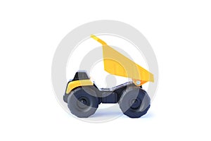 The yellow toy car Heavy truck isolated on white background. Children`s tractor toy. Wheel loader construction car model