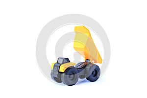The yellow toy car Heavy truck isolated on white background. Children`s tractor toy. Wheel loader construction car model