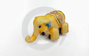Yellow toy elephant on a white background
