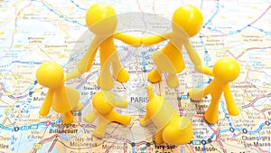 A yellow toy family holding hands exploring Paris