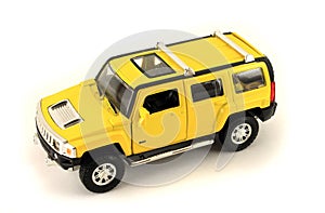 Yellow toy jeep. Isolated object on white background.