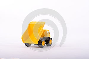 Yellow toy truck isolated on white