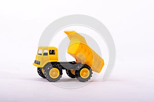 Yellow toy truck isolated on white