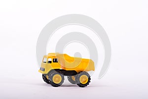 Yellow toy truck isolated on white