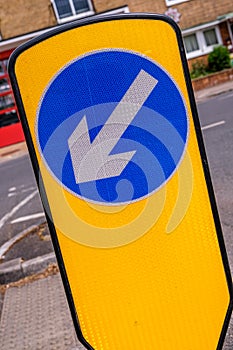 Yellow Traffic Keep Left Island With Blue Circular Direction Arrow