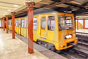 Yellow train coming on subway station, Budapest - Hungary