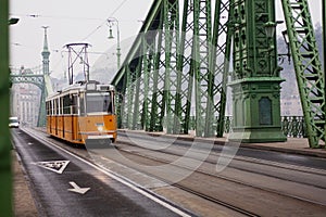 yellow tram on the Freedom Bridge in Budapest, public transport