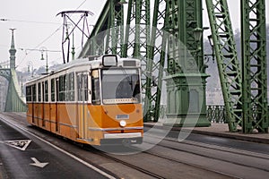 yellow tram on the Freedom Bridge in Budapest, public transport