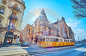 The yellow tram in front of Central Market Hall, Budapest, Hungary