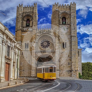 Yellow Tram and Lisbon Cathedral of St. Mary Major Se de Lisboa in Lisbon, Portugal photo