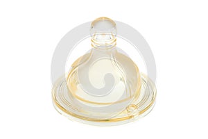 Yellow transparent silicone pacifier on baby feeding bottle.