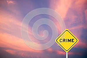 Yellow transportation sign with word crime on violet sky background