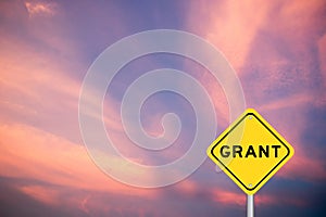 Yellow transportation sign with word grant on violet sky background