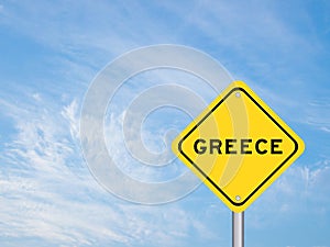 Yellow transportation sign with word greece on blue sky background