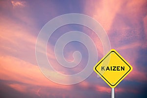 Yellow transportation sign with word kaizen on violet sky