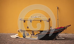 Yellow travel suitcase on wall background