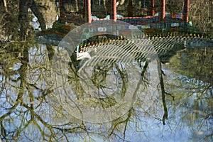 Yellow trees and blue sky are reflected in the quiet river