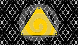 Yellow triangle emblem notice on wire mesh background, caution sign on fence barb grid, copy space, empty warning sign template