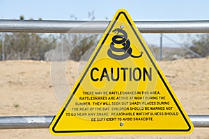 A yellow triangle sign with Snake caution warning