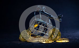 Yellow trolley overturn on stack of golden bitcoin, Bitcoin fall out fron trolley with black background, Focus on bitcoin in front