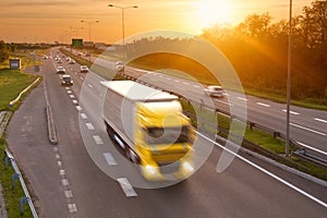 Yellow truck in the rush hour on the highway