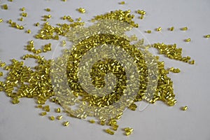 Yellow tubular toho beads on light cream background