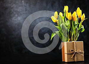 Yellow tulips on dark background