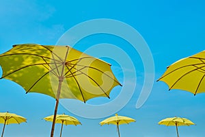 yellow umbrella against blue sky