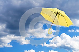 Yellow umbrella against sky