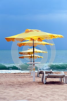 Yellow umbrella on a flooded beach