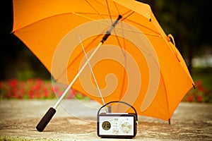 Yellow umbrella and radio receiver on a sunny day