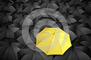 Yellow umbrella standing out of other ones, above view