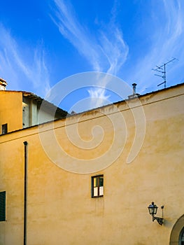 yellow urban house under blue sky in Florence