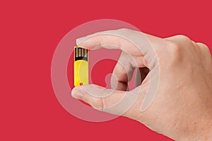 Yellow USB Flash drive on hand with isolated red background