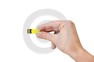 Yellow USB flash memory on hand with isolated white background