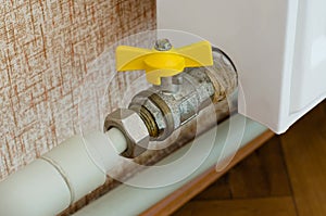 Yellow valve for shutting off heating radiators photo