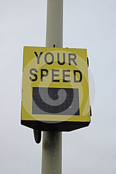 Yellow vehicle activated speed sign showing speed to driver