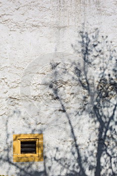 Yellow Ventilation Window and Shadow of Tree at Chateau de Neuchatel - Neuchatel, Switzerland