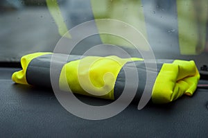 yellow vest on dashboard in car symbol of yellow vest
